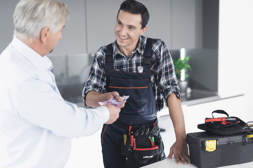 client paying plumber for work done