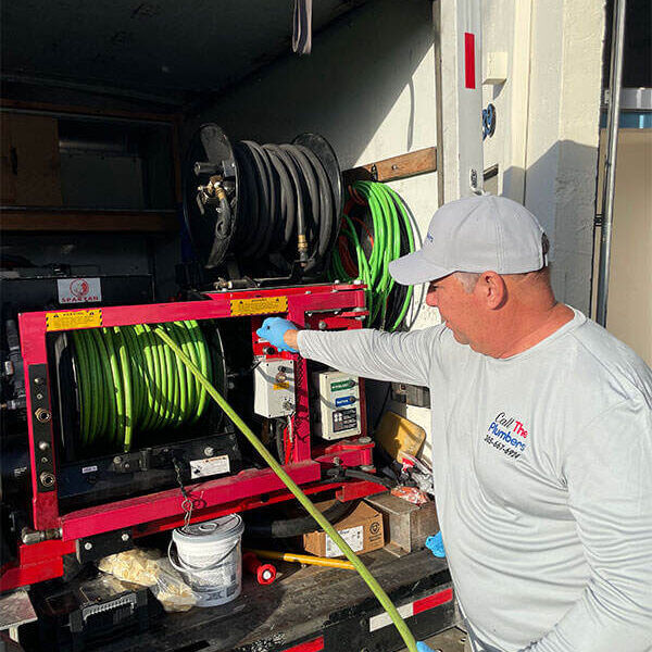 plumber performing drain jetting